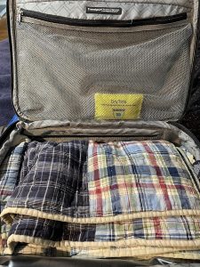 Wisedry 100g rechargeable desiccant pack with a flat fabric body and handle loop, sized to sit in an open gear-case slot without being crushed