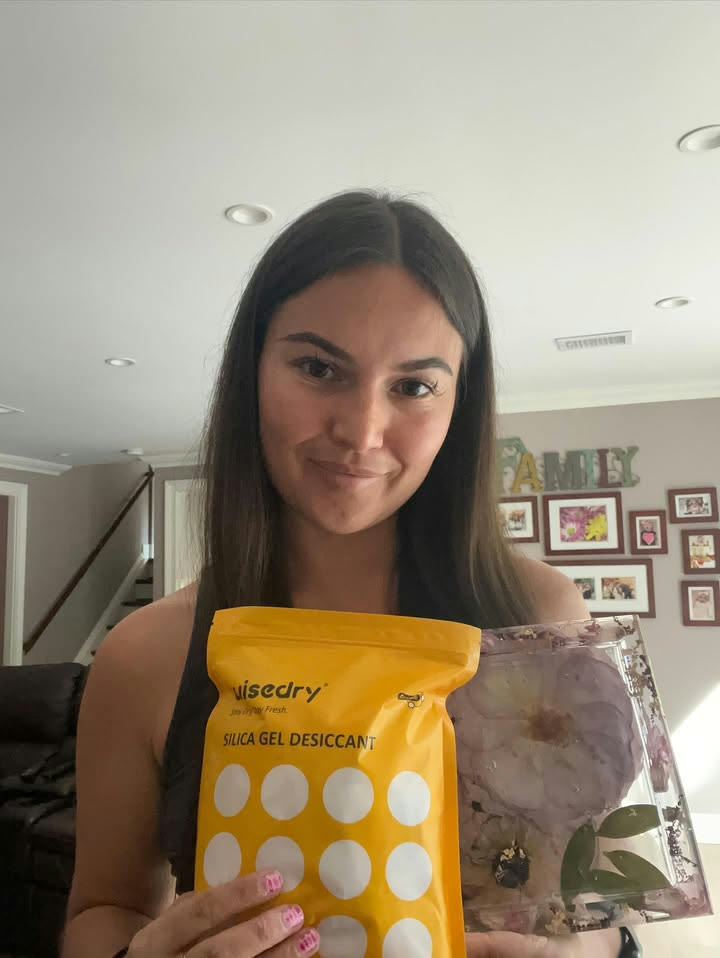 Customer holding Wisedry silica gel desiccant beside preserved flower resin art