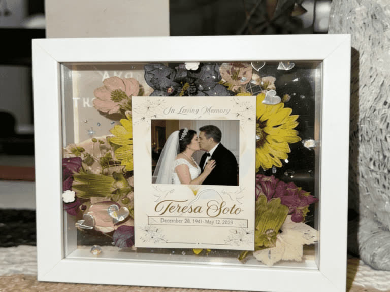 Memorial shadow box with preserved flowers and a family photo