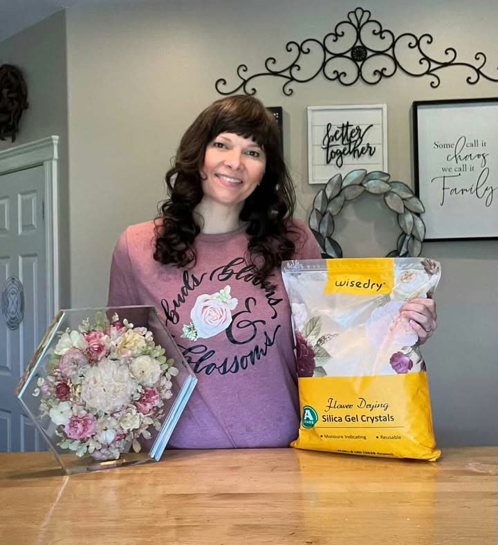 Tricia holding Wisedry flower drying silica crystals beside preserved flowers