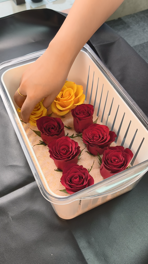 Rose blooms being placed into Wisedry silica gel crystals for supported flower drying