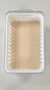 Silica gel base layer in a Wisedry flower drying container before flowers are placed