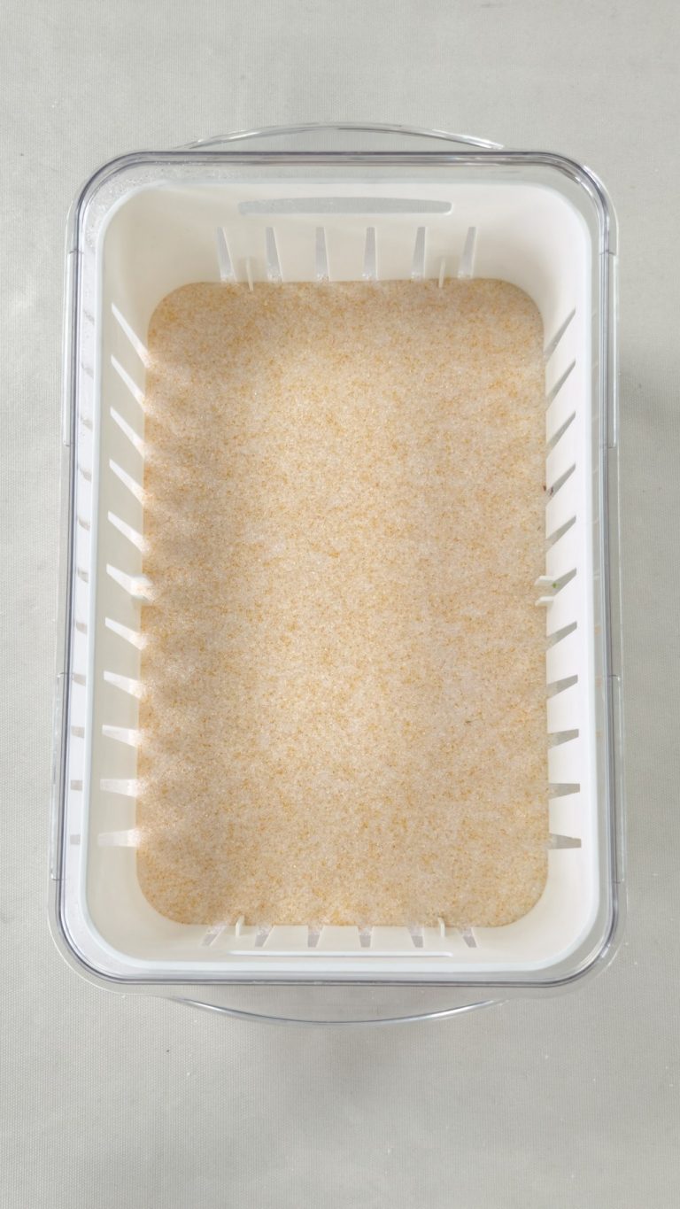 Silica gel base layer in a Wisedry flower drying container before flowers are placed